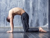 Man does cat yoga pose thumbnail