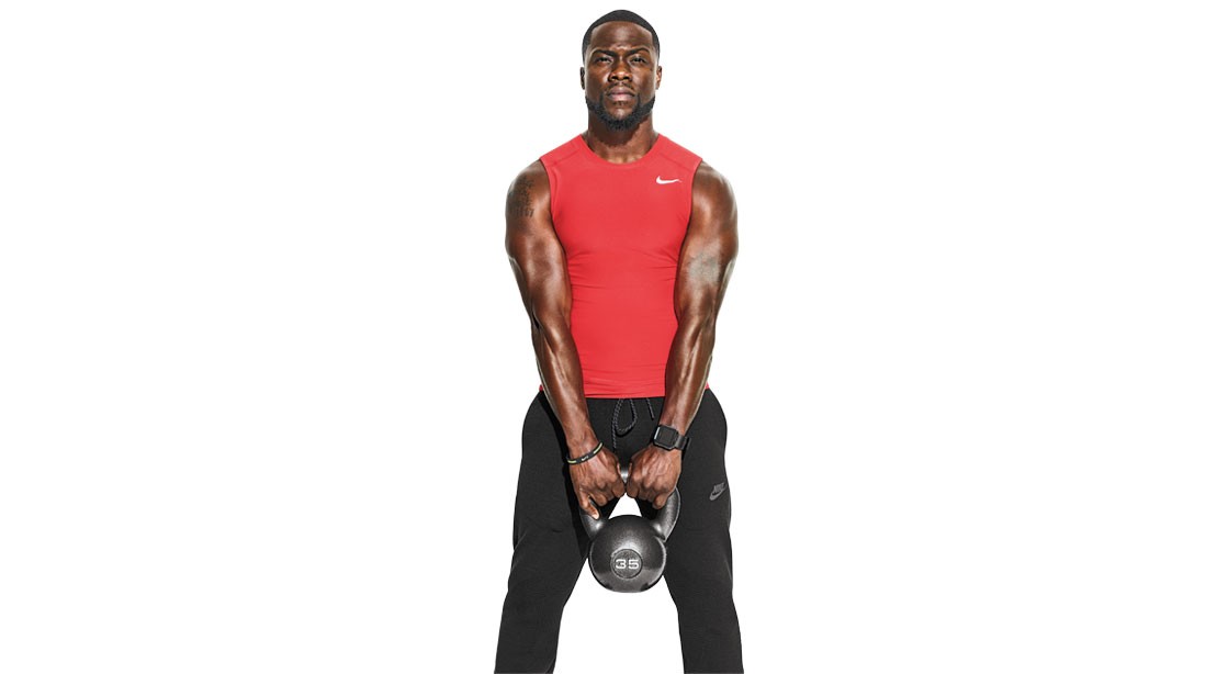 Colossal Comic: Kevin Hart's Upper Body Workout Muscular Kevin Hart holding a kettlebell with red shirt on