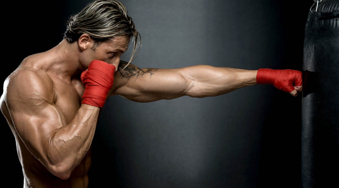 Muscular-Boxer-Punching-Heavy-Bag Muscular-Boxer-Punching-Heavy-Bag