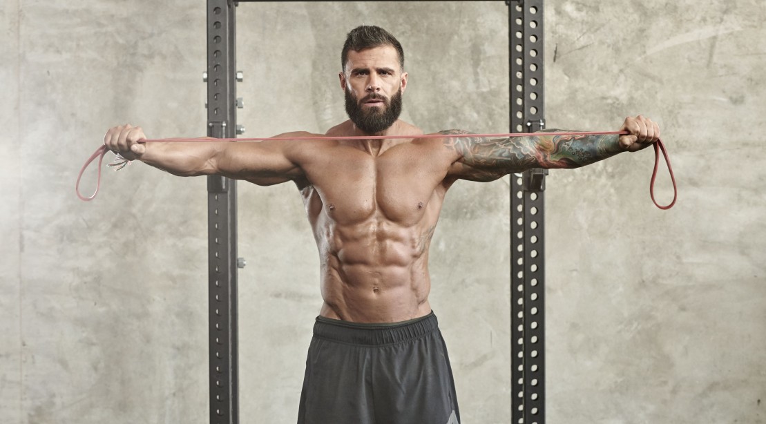 Athletic Man Doing Resistance Band Pull-apart Athletic Man Doing Resistance Band Pull-apart
