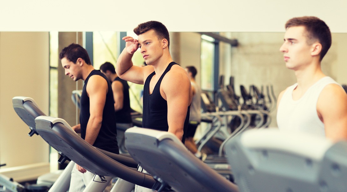 Men Running on the Treadmill in the Gym Men Running on the Treadmill in the Gym