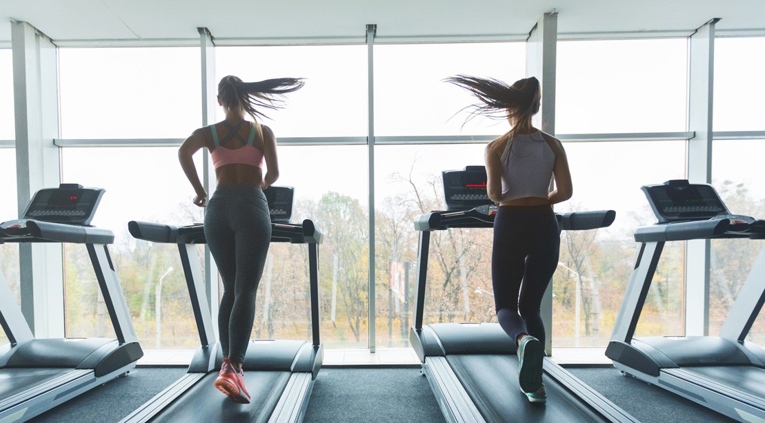 Women Running on a Treadmill in the Gym Women Running on a Treadmill in the Gym
