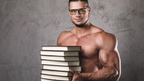 Muscular-Man-Wearing-Glasses-Holding-Stack-of-Books thumbnail
